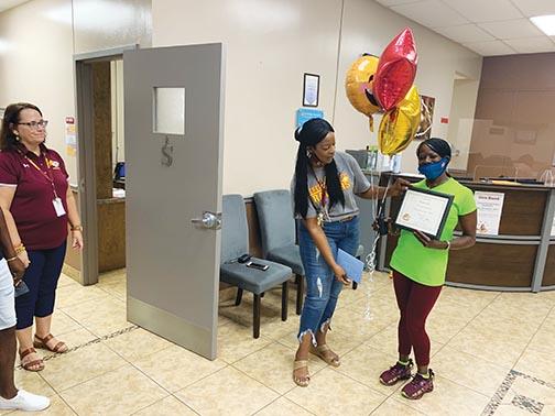 Crescent City Junior-Senior High Assistant Principal Tina Gilyard presents paraprofessional Ronda Jara as the school’s Paraprofessional of the Month.