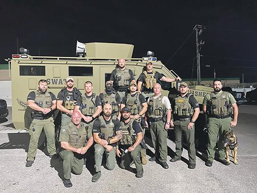 Putnam County Sheriff’s Office deputies gather early Sunday morning before heading to Nassau County to assist in the search for the suspect in the fatal shooting of a Nassau County Sheriff’s Office deputy.