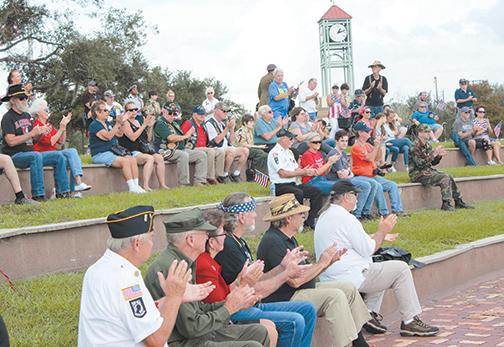 Community members applaud during a previous Veterans Day ceremony at the Palatka riverfront amphitheater.