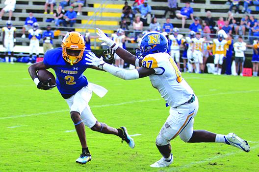 Palatka’s Roderris Passmore tries to avoid the tackle attempt of Newberry’s Gage Thompson during the first quarter of Friday night’s game. (MARK BLUMENTHAL / Palatka Daily News)