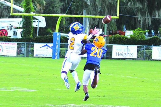 Newberry’s Perrion Sylvester (2) has the ball knocked away from him on a pass attempt by Palatka's Chavaris Dumas. (MARK BLUMENTHAL / Palatka Daily News)