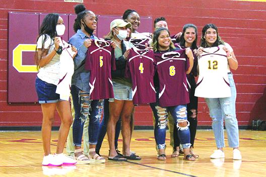 Members of the 2011 Raiders team that went to the FHSAA 1A Final Four in Kissimmee and finished 22-7 pose for pictures with their uniforms from that season. (MARK BLUMENTHAL / Palatka Daily News)