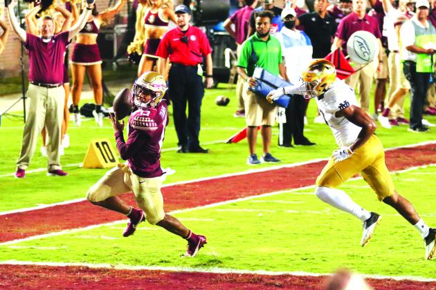 Florida State starting quarterback Jordan Travis outraces a Notre Dame defender to score a touchdown during Sunday night’s overtime thriller in Tallahassee. (GREG OYSTER / Special To The Daily News)