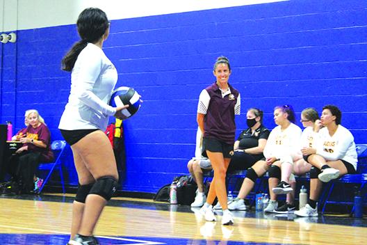Crescent City coach Ashley Jones smiles while giving instruction to Karina Pecina during Tuesday’s match against Interlachen. (MARK BLUMENTHAL / Palatka Daily News)