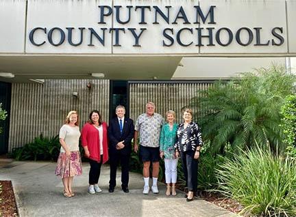 Putnam County School District Executive Director of Federal Programs Melissa Coleman, Assistant Superintendent of Curriculum and Instruction Laura France, Superintendent Rick Surrency, Charles Smith and Joyce Oliver of the Frank V. Oliver, Jr. Foundation and district Director of Career and Technical Education Renee Hough stand outside of district headquarters. The foundation bestowed the district $100,000 toward expanding career and technical education for students.