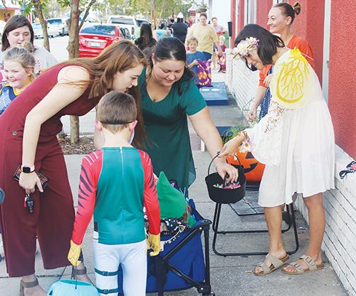 The adults sometimes have to help the youngest trick-or-treaters during Boo on the Avenue, which is slated to return this year.