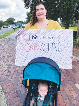 Jani Baldwin of Welaka, accompanied by her 3-month-old son, Jackson Knight, prepares to take part in the Palatka March for Women’s Reproductive Rights, which she organized.