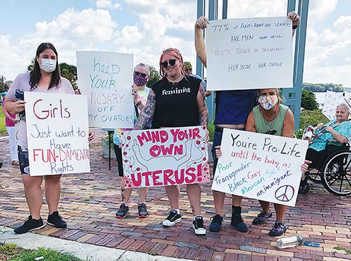 Participants in the Palatka March for Women’s Reproductive Rights gather at the Millennium Clock Tower in Palatka before the event begins Saturday afternoon.
