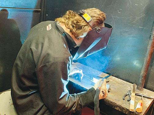 DeRossett uses Tungsten Inertia Gas welding on a piece of metal.