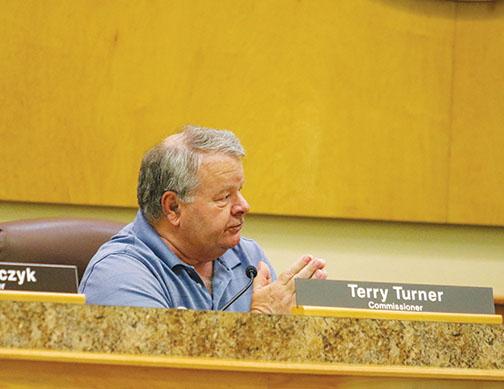 County Commissioner Terry Turner talks to county administrators Wednesday about lowering the countywide millage rate.