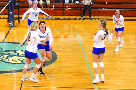 Peniel Baptist Academy volleyball teammates celebrate a fourth-set kill by Brook Williams (front, left) during Thursday night’s victory at Tuten Gymnasium against Crescent City. (MARK BLUMENTHAL / Palatka Daily News)