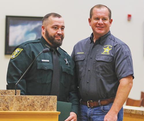 Putnam County Sheriff’s Office Deputy David Fiske smiles with Sheriff Gator DeLoach on Tuesday after being awarded the Sheriff’s Achievement Award.