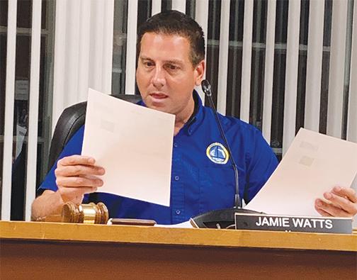 Welaka Mayor Jamie Watts reviews prices and other information relating to the replacement of sewage system equipment during Tuesday night’s town council meeting.