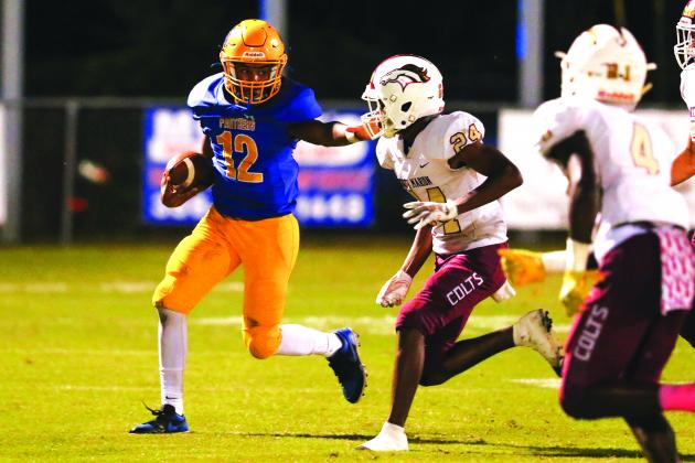 Palatka quarterback Jamarrie McKinnon tries to push his way for yardage against North Marion’s Di’amontae Faison during Friday night’s game at Bennett-Cooper Field at Veterans Memorial Stadium. (GREG OYSTER / Special To The Daily News)