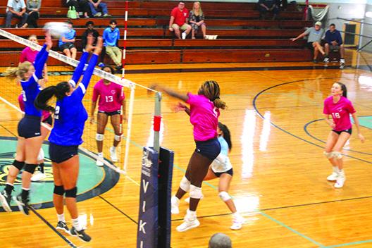 St. Johns River State College’s Kendall Hatchett delivers a kill over Florida State College-Jacksonville’s Anna Trest (left) and Albany Blanco (2) during the second set. (MARK BLUMENTHAL / Palatka Daily News)