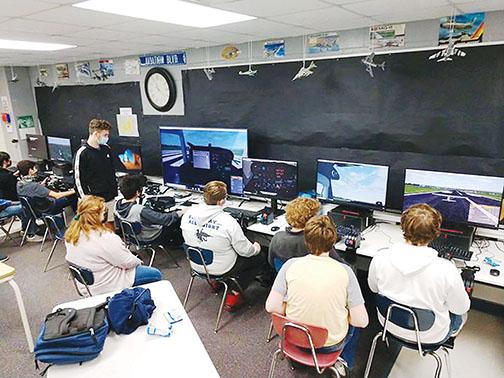Q.I. Roberts Junior-Senior High School students participate in a flight simulation at the school.