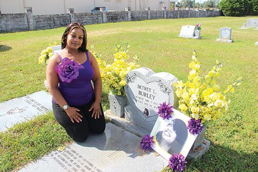 Delola Burley, 44, of Palatka visits the grave of her identical twin sister, Detret Burley, who in 2015 was killed in a double homicide-suicide in East Palatka.
