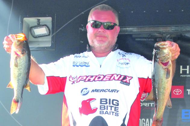 David Lowery holds up two of his winning fish that sealed his victory at the MLF Phoenix Bass Fishing League regional tournament. (GREG WALKER / Daily News correspondent)