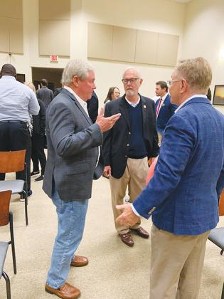 From left, Putnam County Commissioner Bill Pickens and his brother, St. Johns River State College President Joe Pickens, talk with community redevelopment specialist Quint Studer following Studer’s address at a public information session Wednesday.