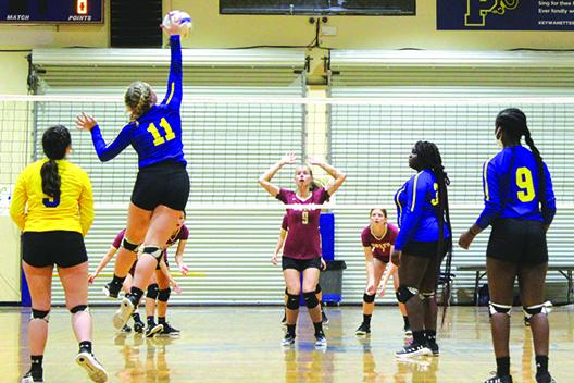 Palatka’s Chloe Barnette puts a kill down in front of North Marion’s Alexa Switzer (9) during Thursday night’s match at Palatka. (MARK BLUMENTHAL / Palatka Daily News)