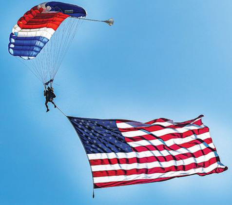 A skydiver displays the American flag during Saturday’s exercise.