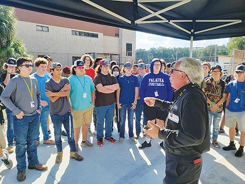 A Universal Technical Institute employee teaches students about working on a 1923 Model T-Bucket Roadster at Palatka Junior-Senior High School on Wednesday.