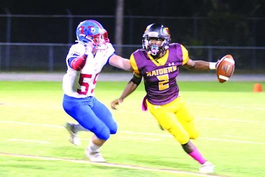 Crescent City quarterback Naykeem Scott does all he can to avoid the sack attempt of Jacksonville Wolfson’s Erik Sheets during the Raiders’ 47-21 victory on Oct. 23, their last regular-season game. (MARK BLUMENTHAL / Palatka Daily News)