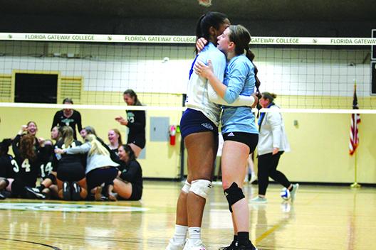 Former Middleburg High School volleyball teammates Mone Gordon (left) and Mikayla Simmons hug after Simmons’ Lake-Sumter team defeated Gordon’s St. Johns River team for the Gulf District title. (MARK BLUMENTHAL / Palatka Daily News)