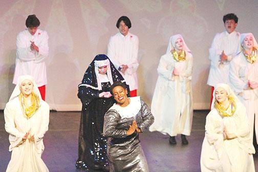 Chuckia Tolbert (center, as Deloris Van Cartier) and Jeanie Elledge Collins as Mother Superior (center, behind Tolbert) perform “Spread the Love Around” from the stage adaptation of the 1992 film “Sister Act” as part of the revue show, “All Together Now!”