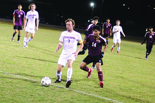 Jacksonville Episcopal’s Will Dannheim tries to control the ball with Crescent City’s Angel Consuelos behind him during the second half of Tuesday night’s 5-1 Raiders victory over the visiting Eagles. (MARK BLUMENTHAL / Palatka Daily News)