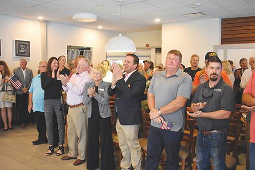 Putnam County business and political leaders, including Mayors Michele Myers and Jamie Watts of Crescent City and Welaka, respectively, applaud as Republican Florida Chief Financial Officer Jimmy Patronis speaks Wednesday.