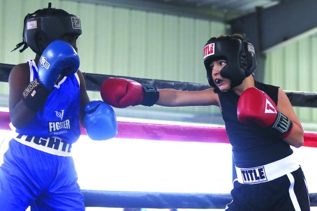 Elijah Velez, right, trying to connect against an unidentified opponent on Nov. 5, won in the 10-year-old Pee Wee Division at 85 pounds as part of the Florida Amateur championships at the East Palatka Fairgrounds. (ALLISON WATERS-MERRITT / Special to the Daily News)