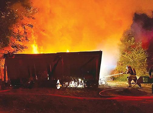 A local firefighter battles flames at a Palatka house fire early Sunday morning.