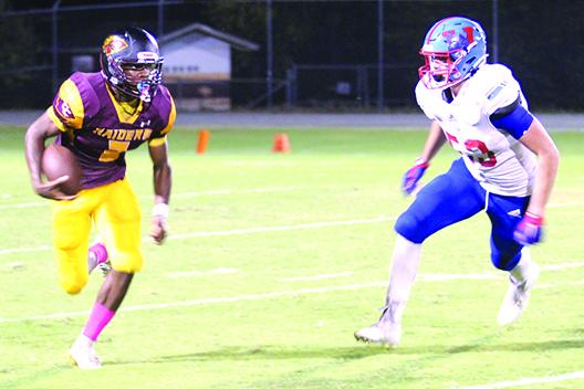 Crescent City Junior-Senior High quarterback Naykeem Scott (left), shown going for yards on the ground against Jacksonville Wolfson on Oct. 22, had the rare distinction of running for over 1,100 yards and passing for over 1,100 yards this season. (MARK BLUMENTHAL / Palatka Daily News0