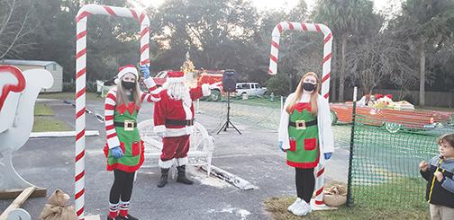 Santa and an elf wave to the community during Interlachen’s 2020 Christmas celebration, which emphasized social distancing.