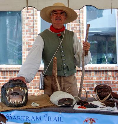A living history actor portraying William Bartram shows his collection of Palatka finds similar to what the real Bartram saw in the 1700s.