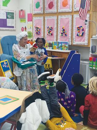 Mother Goose acts out nursery rhymes for a group of Putnam County School District students.