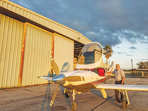 Palatka Municipal Airport Manager John Youell stands by a private aircraft housed in a leased hangar at the airport. 
