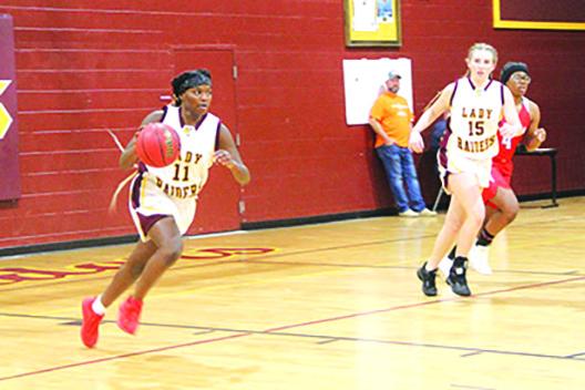 Crescent City’s Amarea Pates brings the ball up the court in the first half of Wednesday’s girls basketball game with Florida Deaf & Blind School. At the right is Crescent City’s Kendall Erkman. (COREY DAVIS / Special to the Daily News)