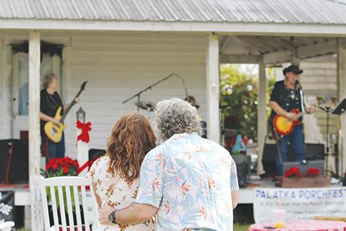 A couple listens to Lazy J & Company on Saturday during Palatka Porchfest. 