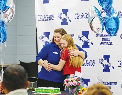 Take Stock in Children mentor Wendy Hansford hugs Williams after the student found out she won the prize.