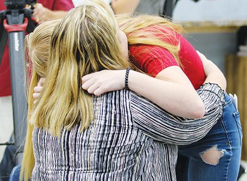 Interlachen High senior Sidney Williams hugs her mom, Ashely Cassels, on Monday.