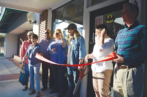 A crowd gathers as the ribbon is about to be cut to celebrate the opening of Hometown Comics & Collectibles, which is also located on St. Johns Avenue in downtown.