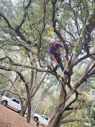 David Loats helps set up and test a master tree-climbing obstacle course in a field off West State Road 20. 