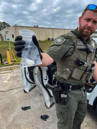 Courtesy of Allison Waters-Merritt. Putnam County Sheriff's Office Deputy James Nehrbass holds meth authorities found in the back of a vehicle Monday.