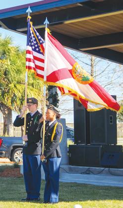 Palatka Junior-Senior High School students Jimmi Beverly and Theodora Foster present the colors Monday while representing the school’s JROTC program.