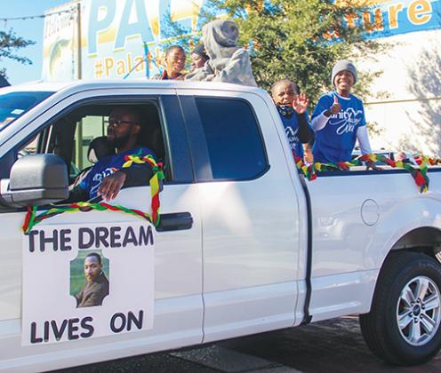 The dream lives on in Palatka as children give a thumbs up from a float in the Martin Luther King Jr. Parade on Monday.
