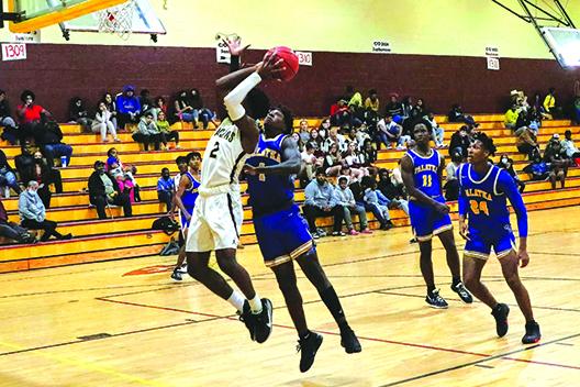 Crescent City’s Naykeem Scott (2) tries to take a shot as Palatka’s Jahmar Brown defends Tuesday night. (RITA FULLERTON / Special to the Daily News)