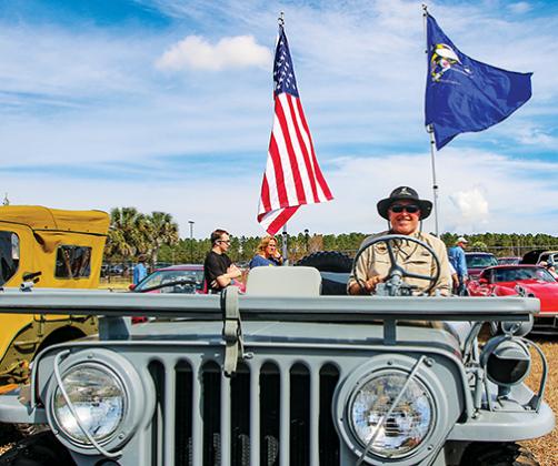 Mark Hooper, of Jacksonville, smiles Saturday in his 1952 M38 Jeep that he fully restored.
