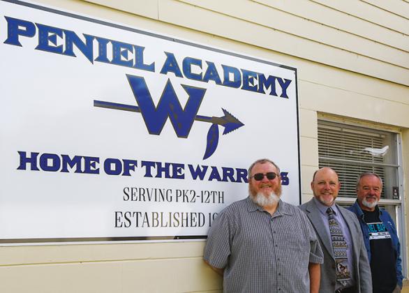 Peniel Academy’s middle school history and Bible teacher Robert Massey stands next to school Administrator Bill Evans and Peniel Baptist Church Senior Pastor Benny Reynolds outside the Palatka school Tuesday.